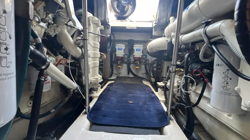 Slide: The Image of Engine room of 2001 Uniesse 42 Open yacht, showcasing mechanical components and systems. - 45