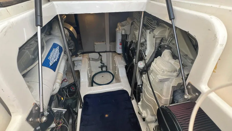 Slide: The Image of Engine compartment of 2001 Uniesse 42 Open yacht, showcasing mechanical components and layout. - 46