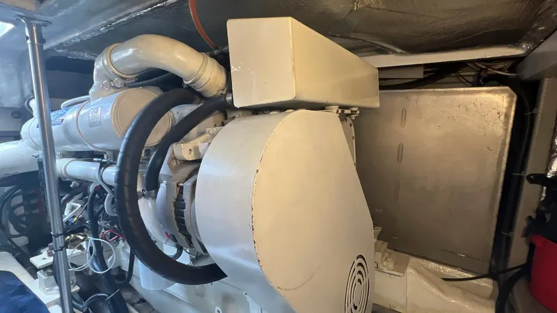 Slide: The Image of Engine room of 2001 Uniesse 42 Open yacht, showcasing mechanical components. - 49