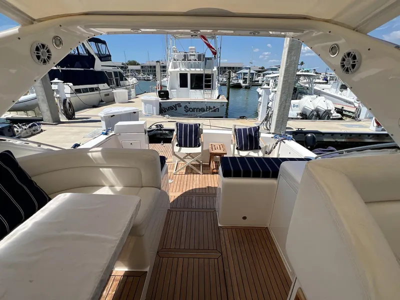 Slide: The Image of Luxury 2001 Uniesse 42 Open yacht interior with elegant seating and marina view. - 7