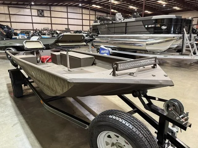Slide: The Image of 1999 Xpress 1546 boat with Mariner 25 engine on trailer in warehouse. - 3