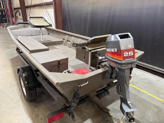 Slide: The Image of 1999 Xpress 1546 boat with Mariner 25 outboard motor on trailer in warehouse. - 5
