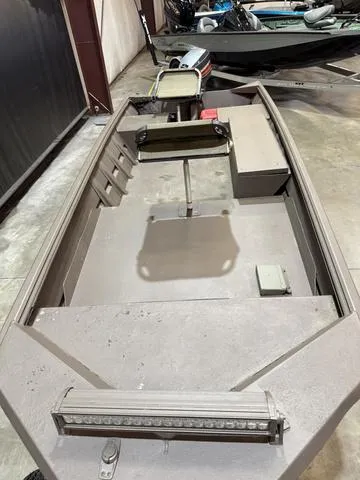 Slide: The Image of 1999 Xpress 1546 boat with Mariner 25 engine, interior view in a garage. - 7