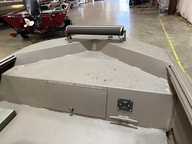 Slide: The Image of 1999 Xpress 1546 W/Mariner 25 boat interior, showing bow area and storage compartment. - 9