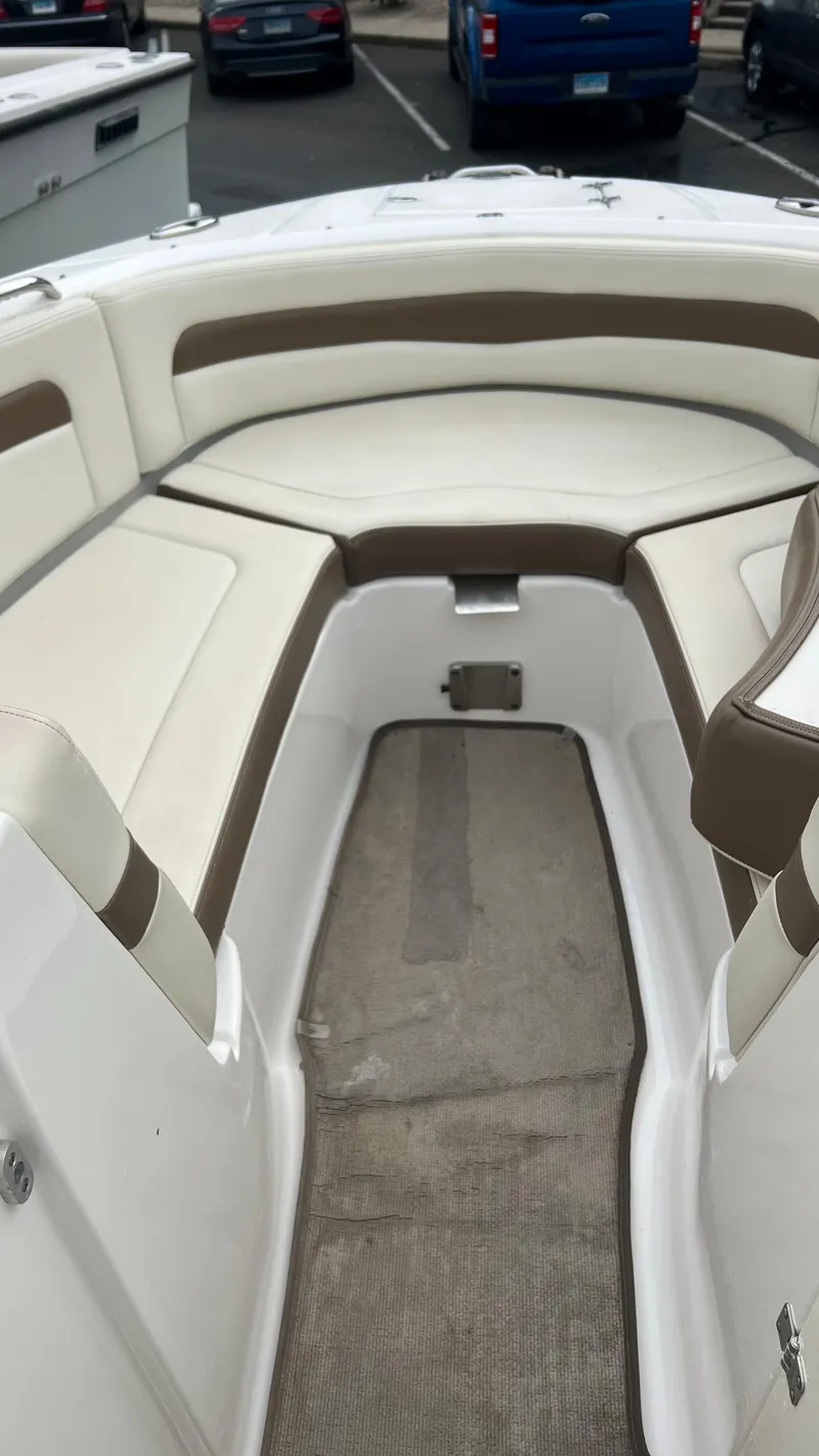 Slide: The Image of 2017 Chaparral 246 SSi boat interior with white and brown seating. - 12