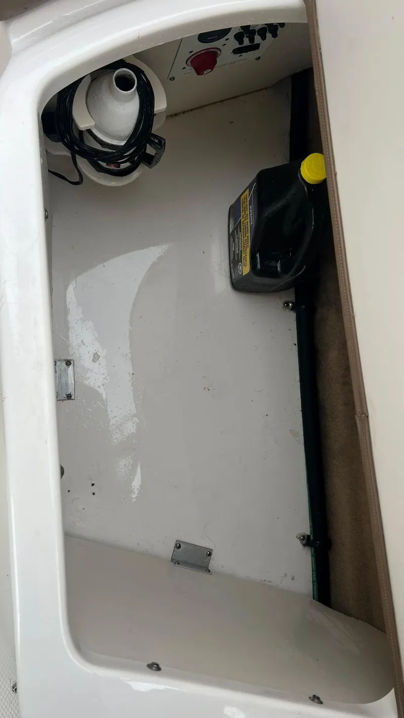 Slide: The Image of 2017 Chaparral 246 SSi storage compartment with cleaning supplies and equipment. - 16