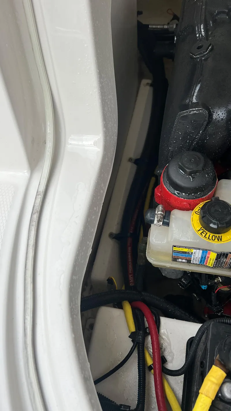 Slide: The Image of Engine compartment of a 2017 Chaparral 246 SSi boat, showing wiring and components. - 17