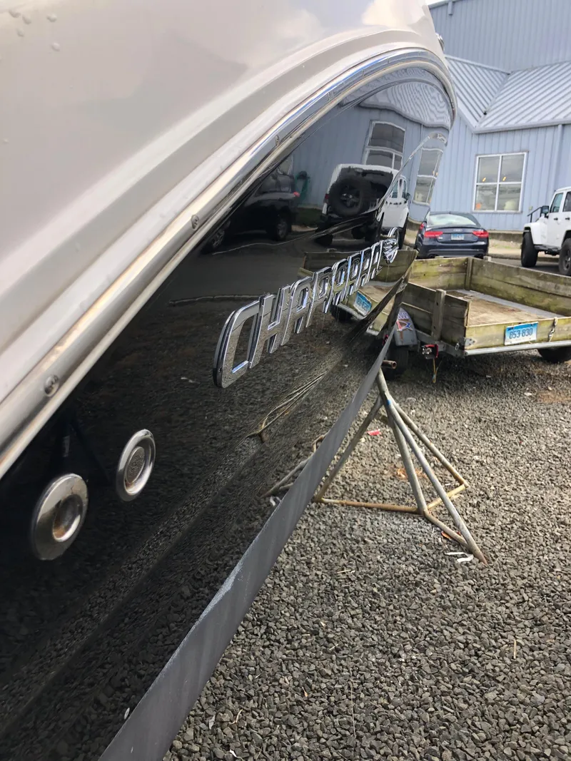 Slide: The Image of 2017 Chaparral 246 SSi boat side view with logo, parked on gravel. - 5