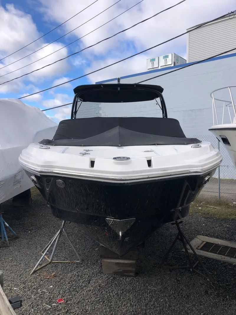 Slide: The Image of 2017 Chaparral 246 SSi boat on display, black and white exterior, parked outdoors. - 7