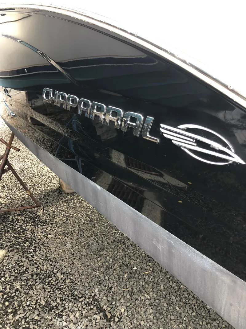 Slide: The Image of 2017 Chaparral 246 SSi boat hull with logo, displayed on gravel. - 8