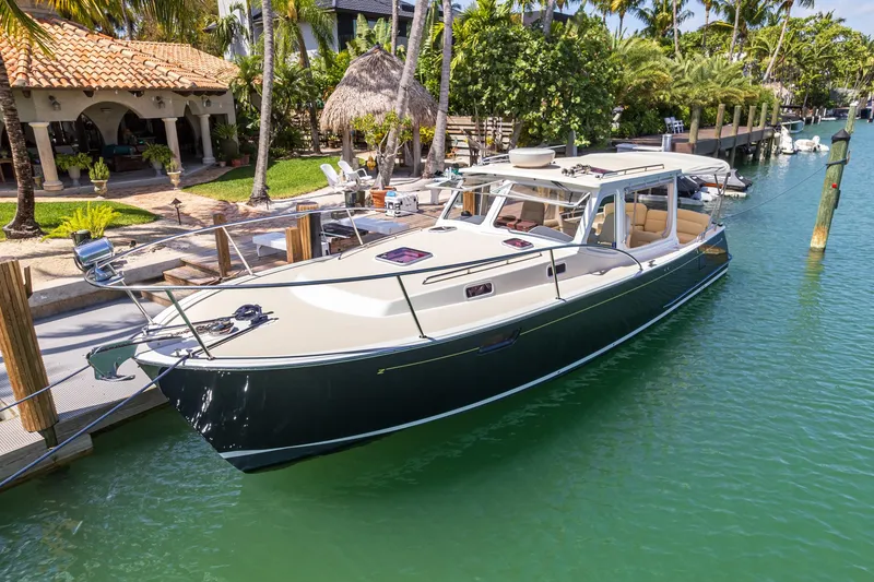 Slide: The Image of 2013 MJM 36z Downeast boat docked in a tropical marina setting. - 12