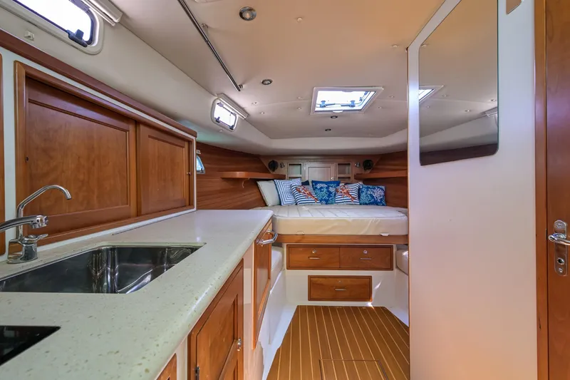 Slide: The Image of 2013 MJM 36z Downeast yacht interior with cozy cabin, bed, and kitchenette. - 22