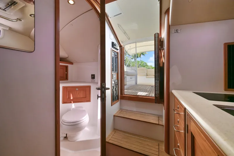 Slide: The Image of Interior of 2013 MJM 36z Downeast yacht, featuring a compact bathroom and wooden cabinetry. - 25