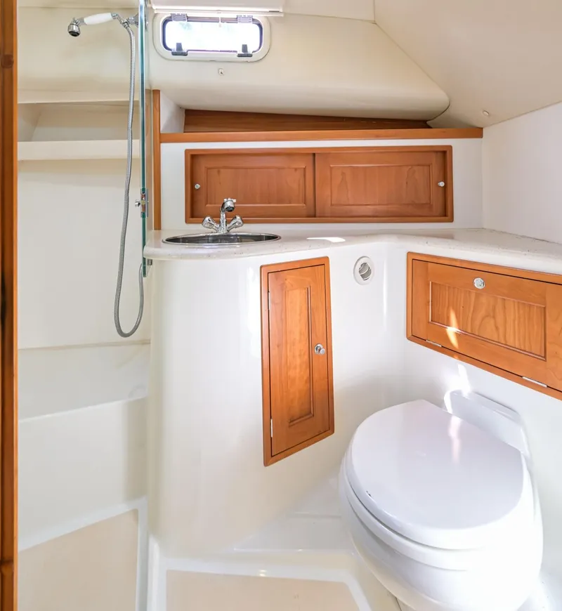 Slide: The Image of 2013 MJM 36z Downeast yacht bathroom with wooden cabinets and modern fixtures. - 26