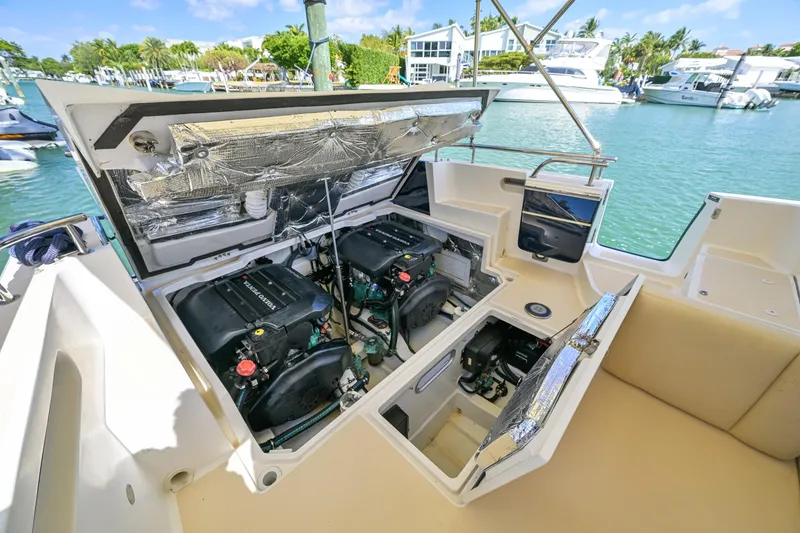 Slide: The Image of 2013 MJM 36z Downeast boat engine compartment open, docked in a marina. - 30