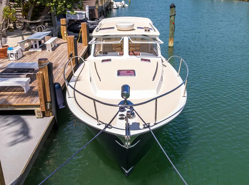 Slide: The Image of 2013 MJM 36z Downeast boat docked in a serene marina setting. - 32