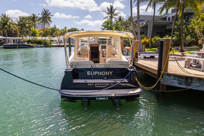 Slide: The Image of 2013 MJM 36z Downeast boat docked in Key Biscayne, Florida, surrounded by palm trees. - 9