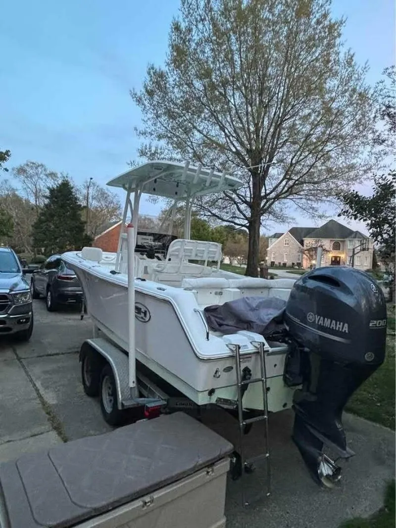 Slide: The Image of 2017 Sea Hunt Ultra 225 boat on trailer with Yamaha engine in residential driveway. - 15