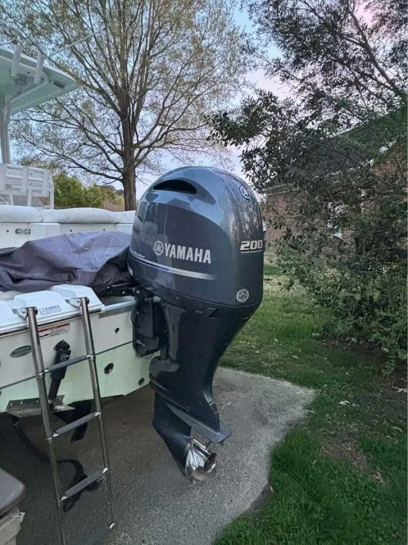 Slide: The Image of 2017 Sea Hunt Ultra 225 with Yamaha 200 outboard motor in a garden setting. - 16