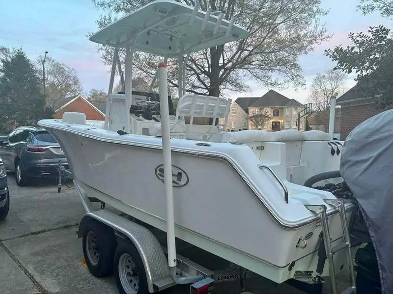 Slide: The Image of 2017 Sea Hunt Ultra 225 boat on trailer in residential driveway. - 19
