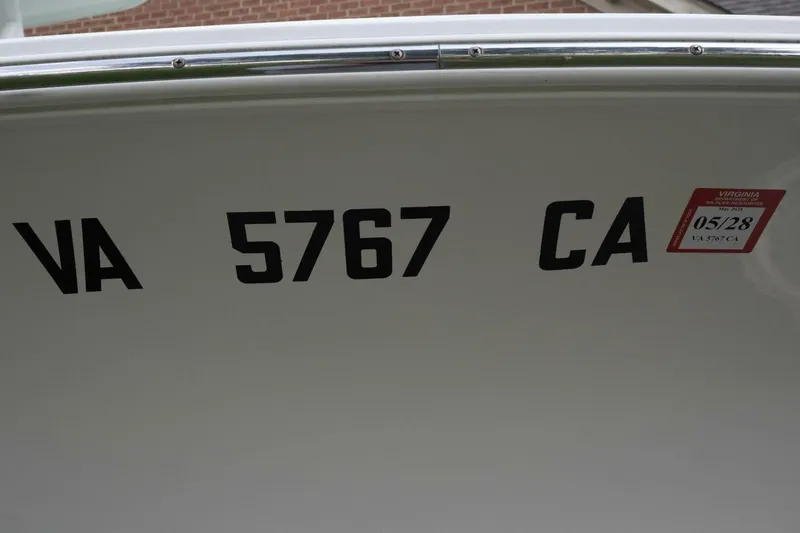 Slide: The Image of 2017 Sea Hunt Ultra 225 boat with registration VA 5767 CA and Virginia sticker. - 26