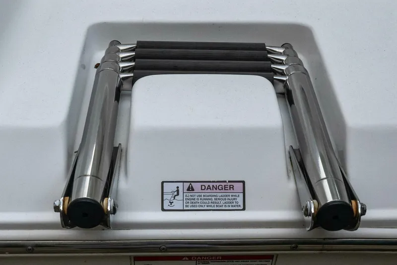 Slide: The Image of Stainless steel boat ladder on 2017 Sea Hunt Ultra 225 with safety warning label. - 32