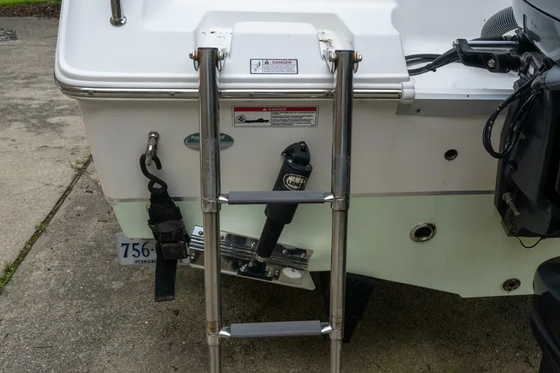 Slide: The Image of 2017 Sea Hunt Ultra 225 boat with rear ladder and motor details. - 33