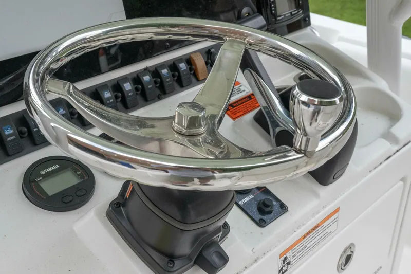 Slide: The Image of Steering wheel of 2017 Sea Hunt Ultra 225 boat with control panel and Yamaha display. - 36
