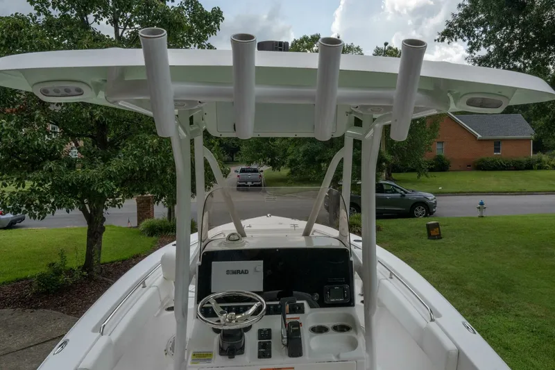 Slide: The Image of 2017 Sea Hunt Ultra 225 boat cockpit with steering wheel and rod holders. - 38