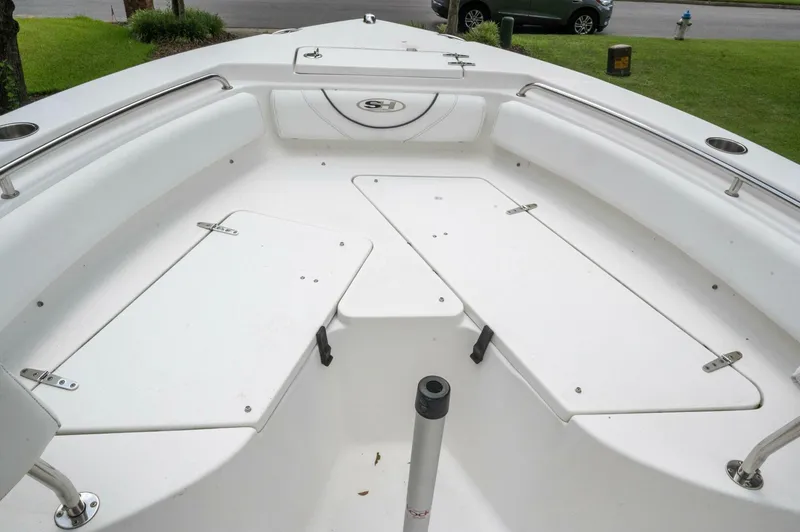 Slide: The Image of 2017 Sea Hunt Ultra 225 boat interior with white seating and storage compartments. - 40