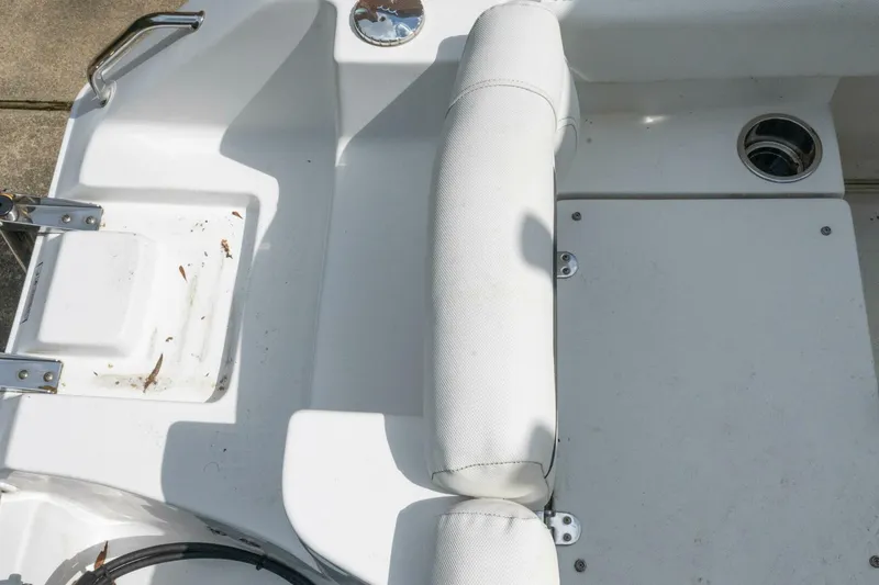 Slide: The Image of 2017 Sea Hunt Ultra 225 boat interior with white seating and stainless steel fixtures. - 43