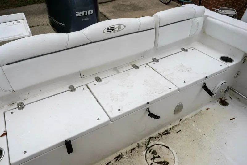 Slide: The Image of 2017 Sea Hunt Ultra 225 boat interior with storage compartments and Yamaha 200 engine. - 45