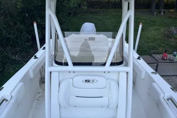 Slide: The Image of 2017 Sea Hunt Ultra 225 boat interior with white seating and console. - 57