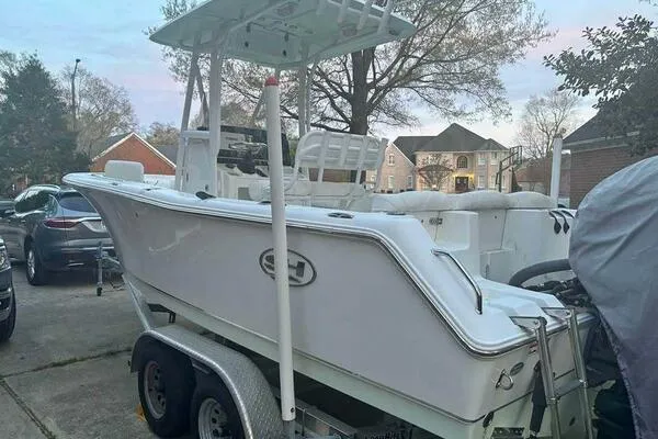 Slide: The Image of 2017 Sea Hunt Ultra 225 boat on trailer in residential driveway. - 58
