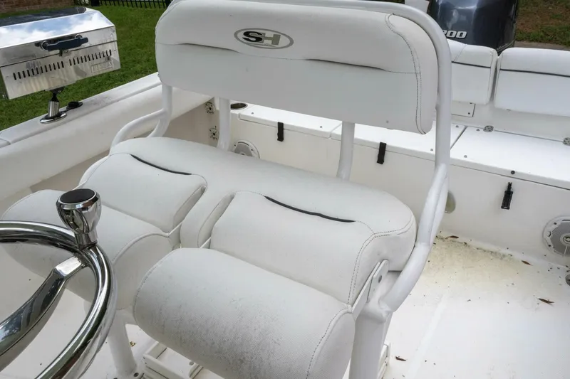 Slide: The Image of 2017 Sea Hunt Ultra 225 boat interior with white seating and steering wheel. - 8