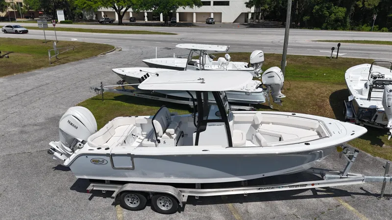 Slide: The Image of 2024 Sea Hunt Ultra 239 SE boat on trailer, parked outdoors. - 3