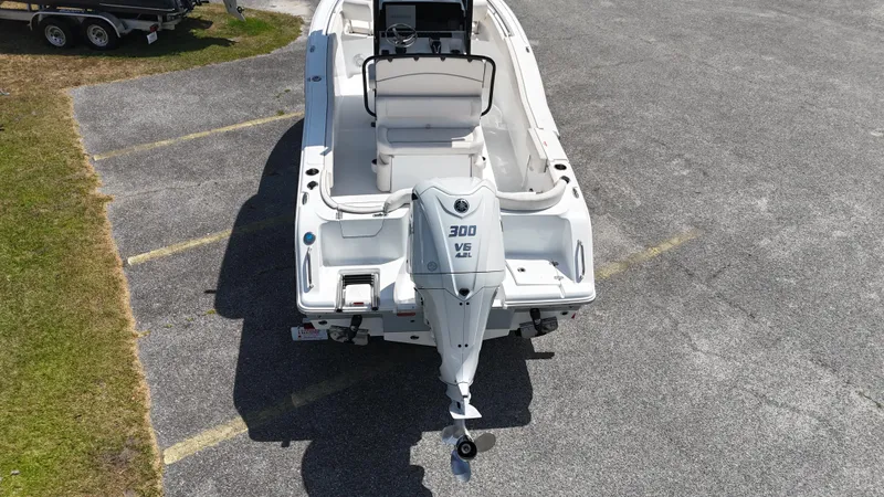 Slide: The Image of 2024 Sea Hunt Ultra 239 SE boat with 300 V6 engine, parked on asphalt. - 5