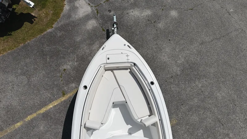 Slide: The Image of 2024 Sea Hunt Ultra 239 SE boat, aerial view, parked on pavement. - 8