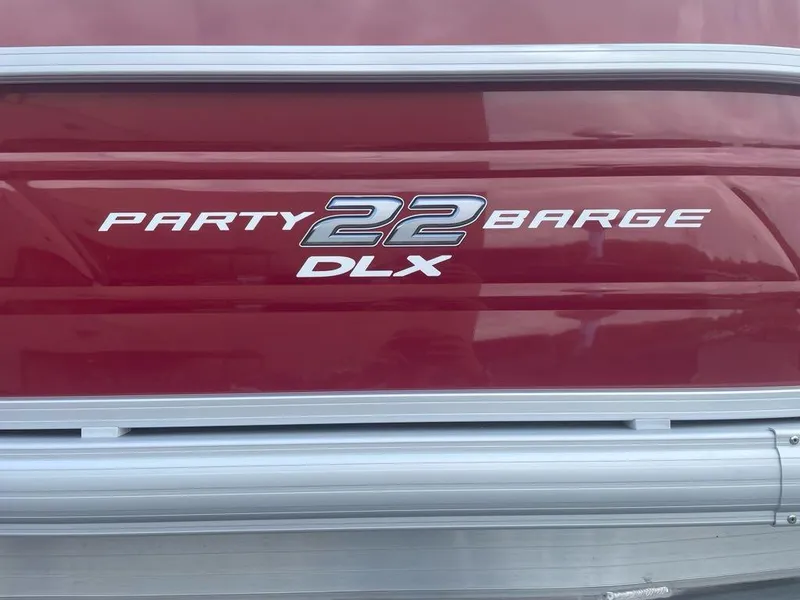 Slide: The Image of 2025 Sun Tracker Party Barge 22 DLX logo on red background. - 2