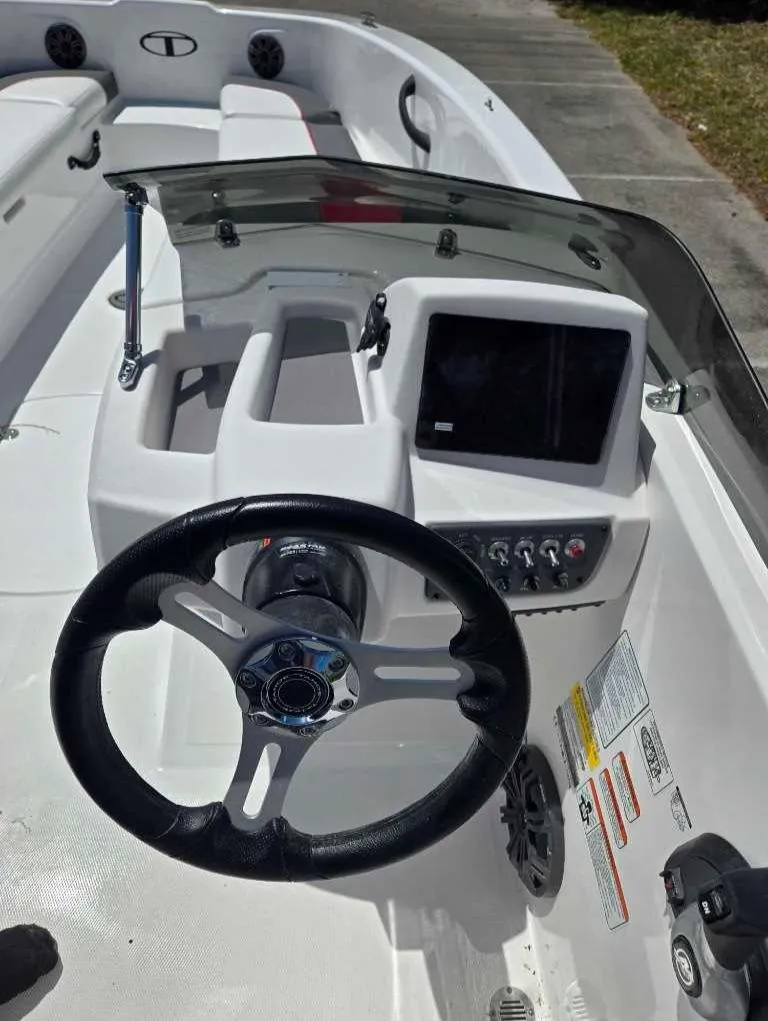 Slide: The Image of 2025 Tahoe T18 boat dashboard with steering wheel and control panel. - 5