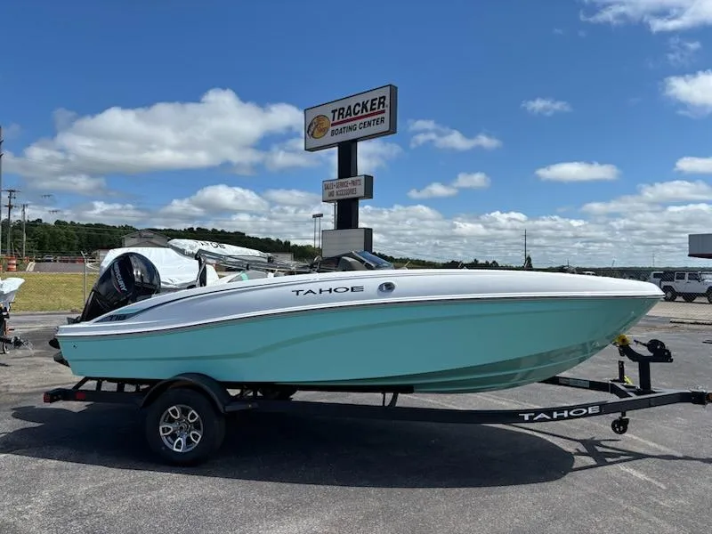 Slide: The Image of 2025 Tahoe T18 boat on trailer at Tracker Boating Center, under a clear blue sky. - 0