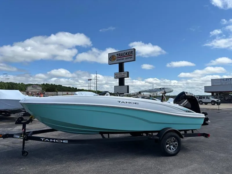 Slide: The Image of 2025 Tahoe T18 boat on trailer under blue sky at dealership. - 1