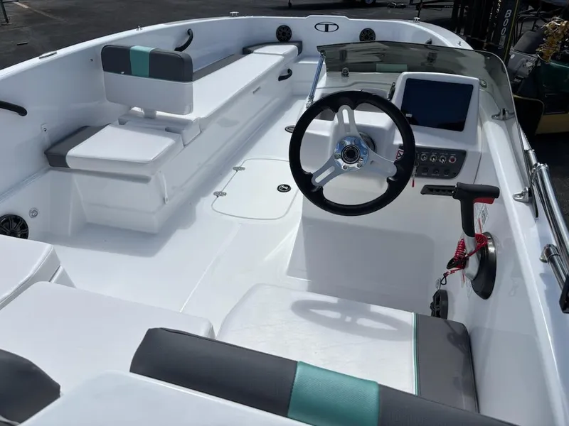 Slide: The Image of 2025 Tahoe T18 boat interior with modern steering, seating, and dashboard. - 3