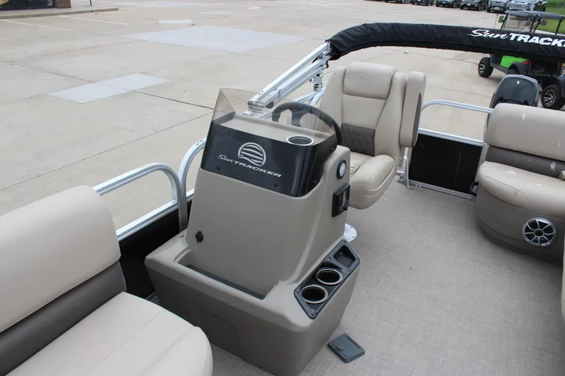 Slide: The Image of 2025 Sun Tracker Party Barge 16 DLX interior with steering console and seating. - 11