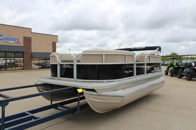Slide: The Image of 2025 Sun Tracker Party Barge 16 DLX pontoon boat on trailer at dealership. - 7