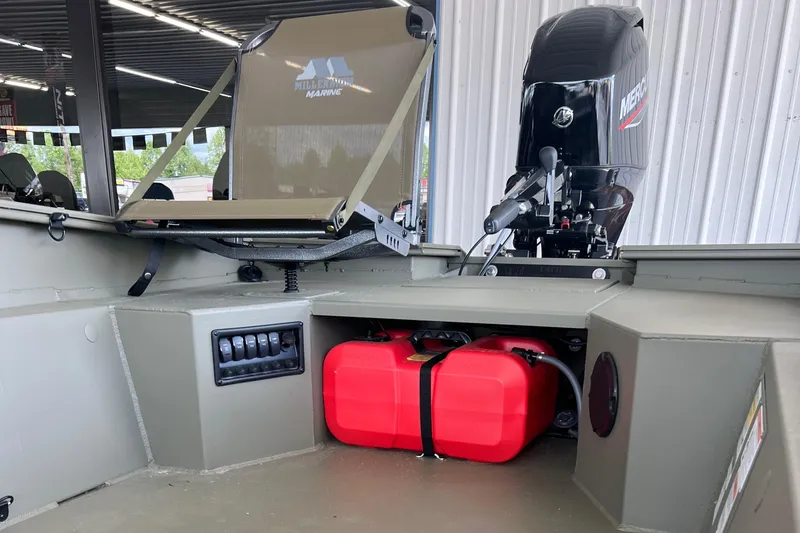 Slide: The Image of 2025 Tracker Grizzly 1650 T Prairie Wings Edition boat interior with motor and red fuel tank. - 8