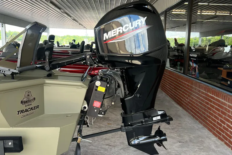 Slide: The Image of 2025 Tracker Grizzly 1650 T Prairie Wings Edition with Mercury outboard motor in showroom. - 9