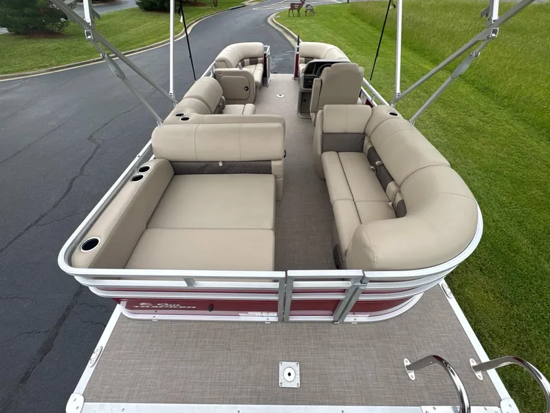 Slide: The Image of 2025 Sun Tracker Party Barge 22 RF DLX pontoon boat with spacious seating and beige upholstery. - 5