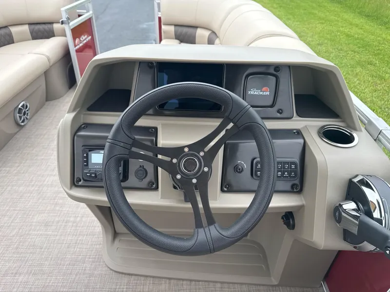 Slide: The Image of 2025 Sun Tracker Party Barge 22 RF DLX steering console with modern controls and comfortable seating. - 7
