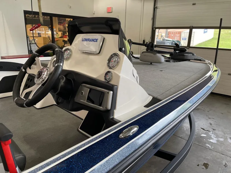 Slide: The Image of 2024 Nitro Z20 boat interior with steering wheel and Lowrance electronics in a showroom. - 2